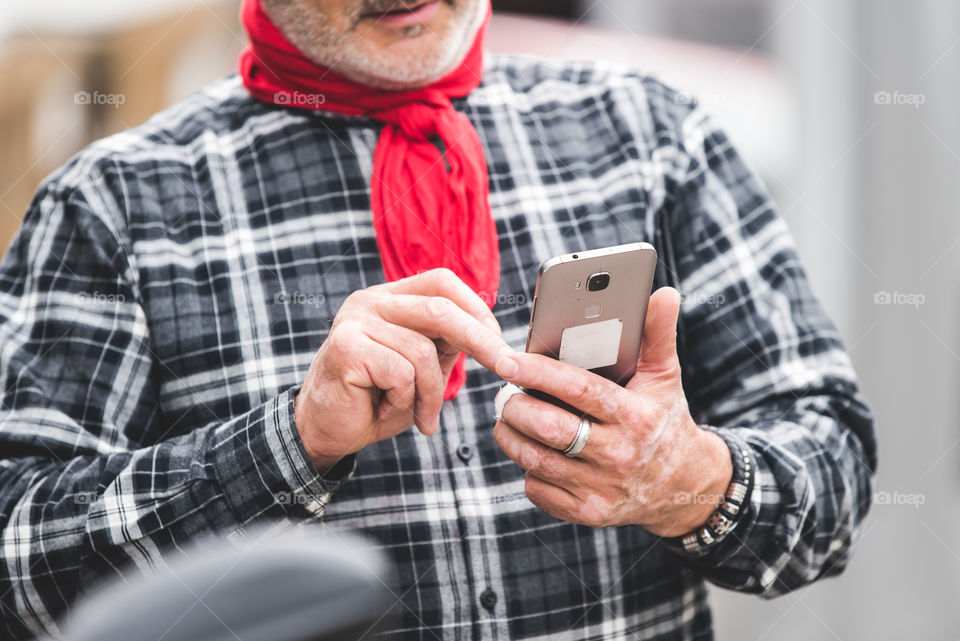 older man using his mobail phone