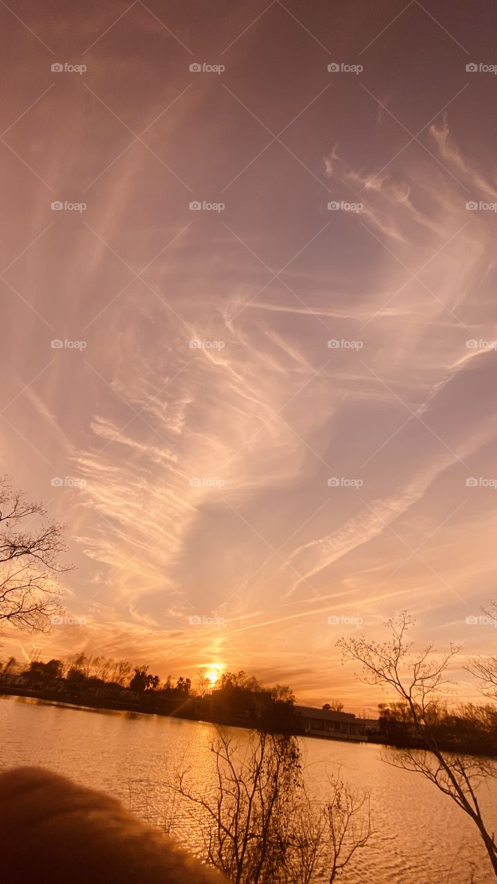 High Clouds adjusting the sky during Sunset. Colors radiating within all the feathering of clouds with wind patterns. 