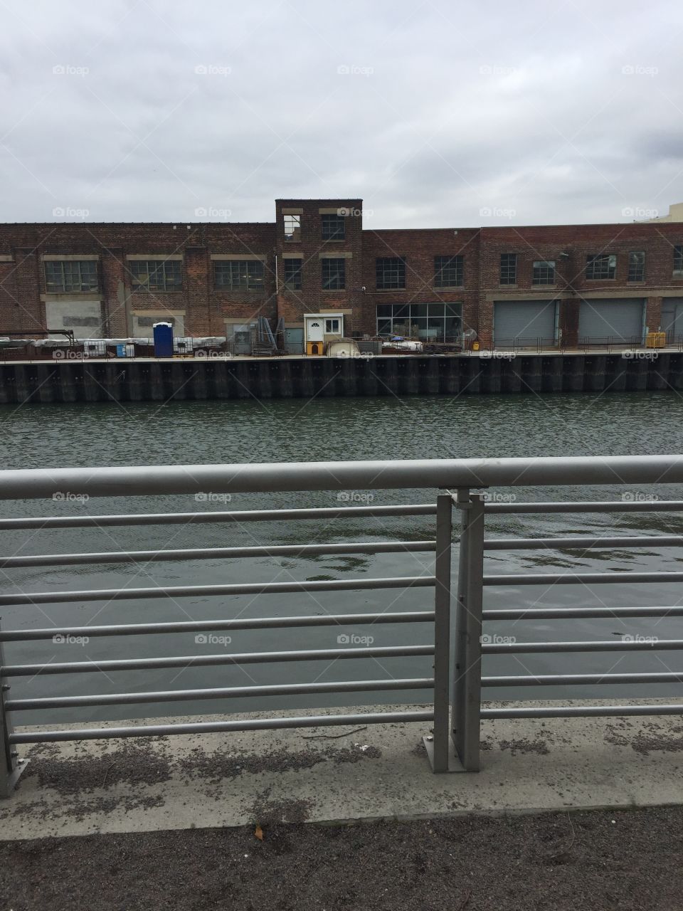 Pier side view of into industrialization . View of the river is also shown.  Taken at Court Square in Queens New York.