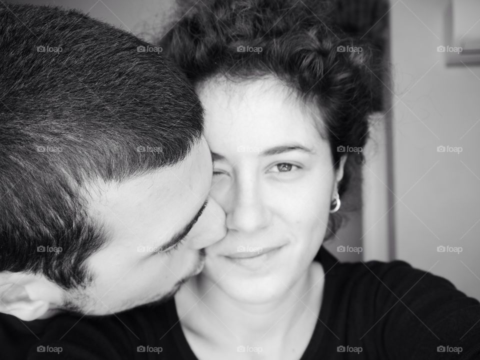 Close-up of a man kissing a beautiful woman