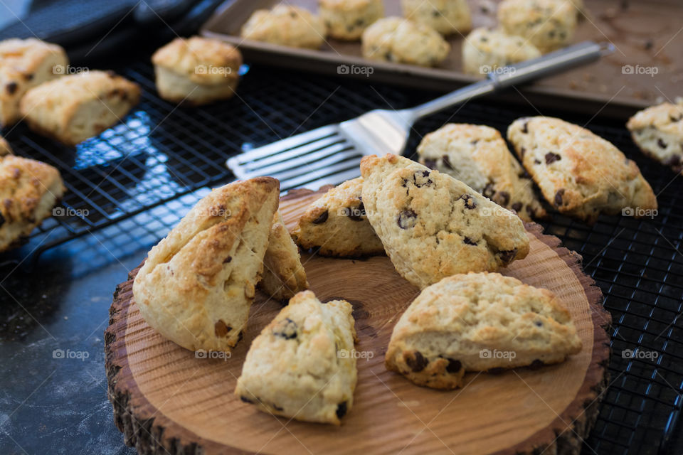 in the kitchen baking and cooking homemade scones with fruit and fresh herbs