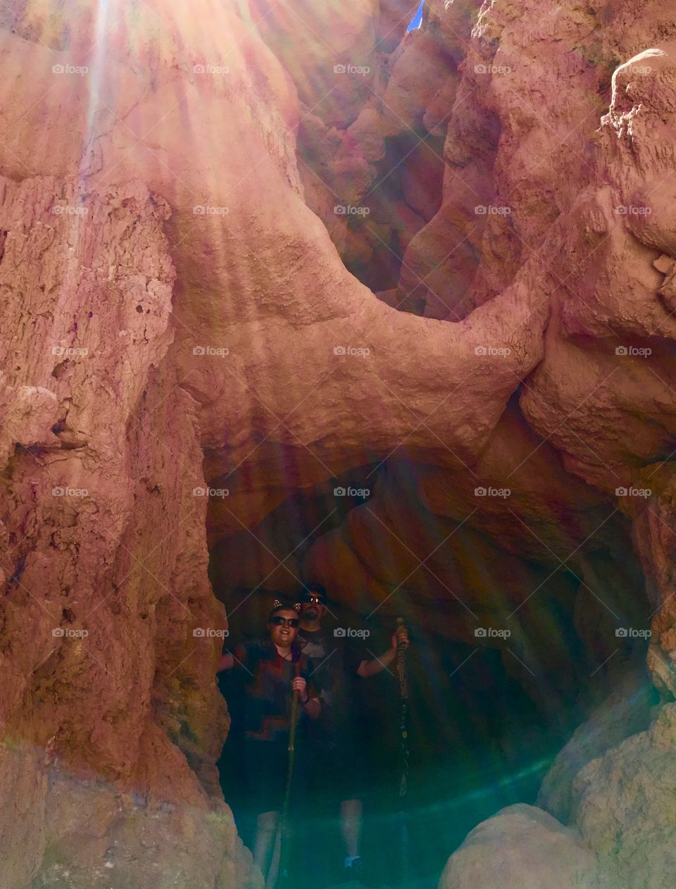 My family cave dwellers as the sun beams over the entrance in Goblin Valley, Utah.