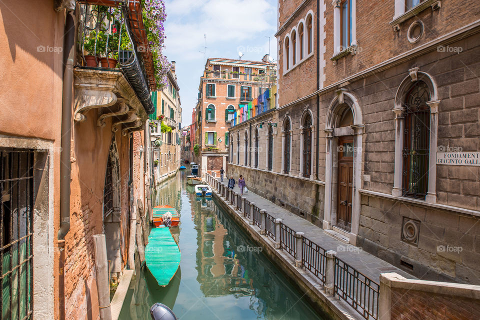 Boats moored in a small canal in venice