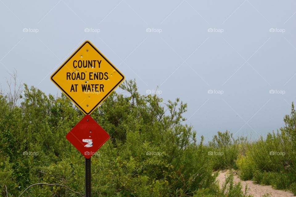 Road ends at water sign. A sign at the edge of the walkway to Sleeping Bear Dunes National Lakeshore