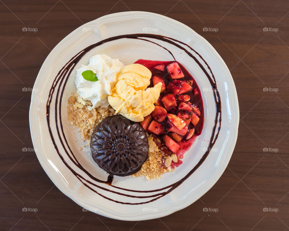 Top view of plate with chocolate sweet and fruits