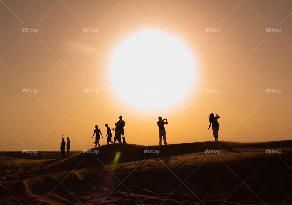Silhouette of people exploring the desert