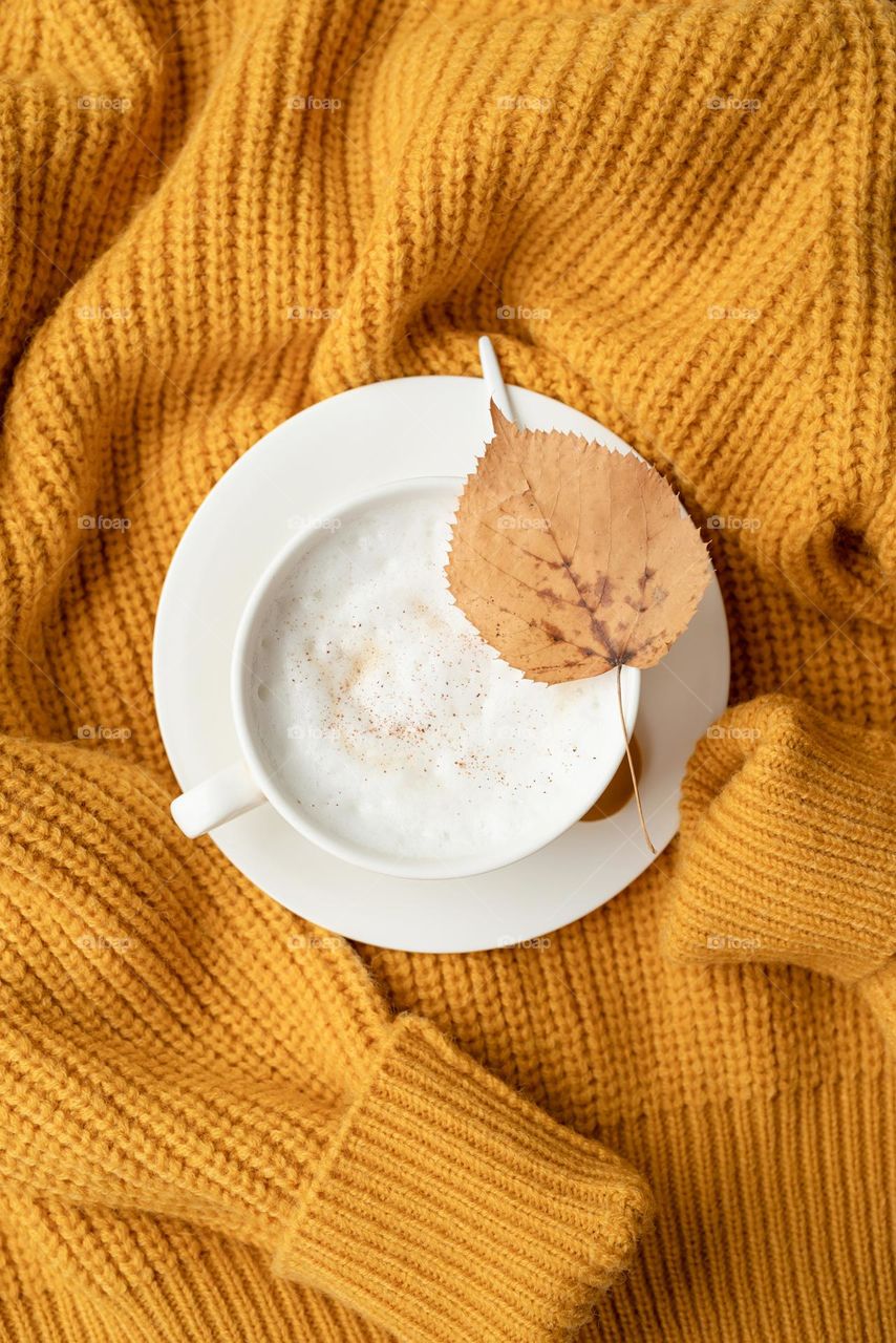 coffee on yellow sweater