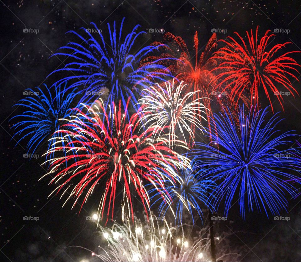 Red White and Blue exploding vivid fireworks.