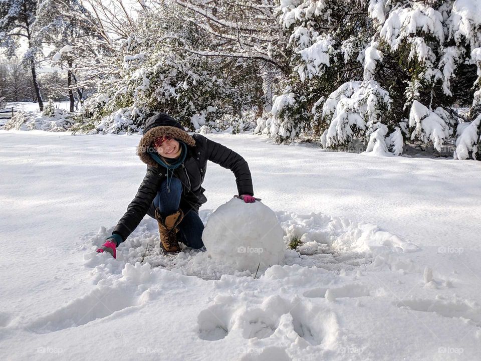 building a snowman in the front yard after the big storm this weekend