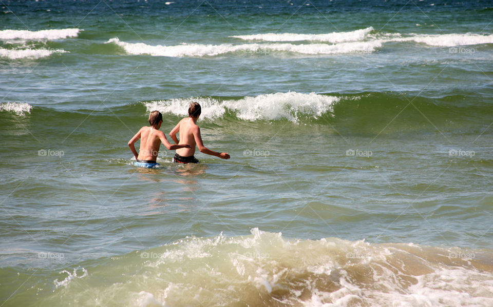 Two boys in the waves. 