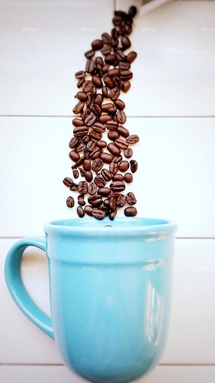 Coffee Beans Close Up with a Blue Mug