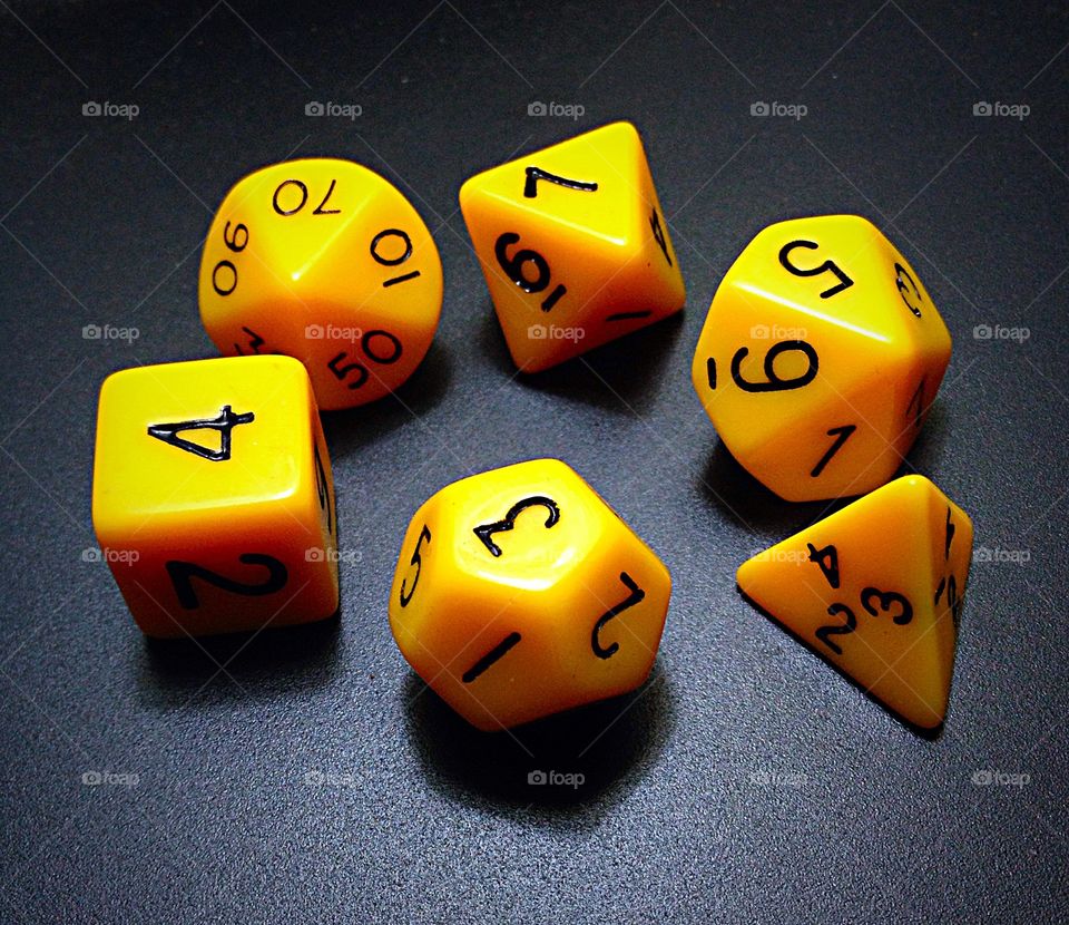 Roll the dice.. Yellow dungeons and dragons dice.