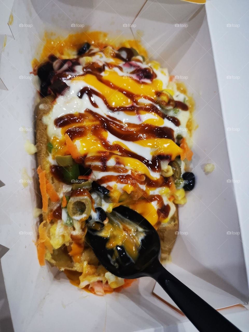 Oven-cooked potatoes and cleanliness with cheese, olives and sauce Russian salad