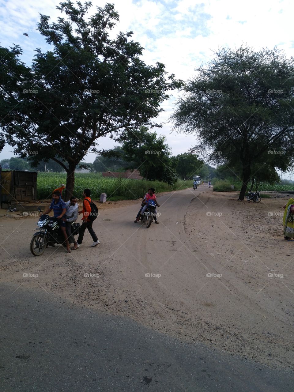 Group of people on motorbikes at countryside road