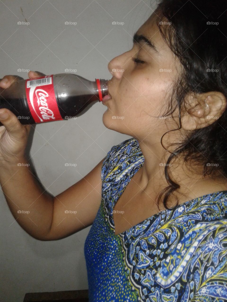 drinking coca cola with tried face