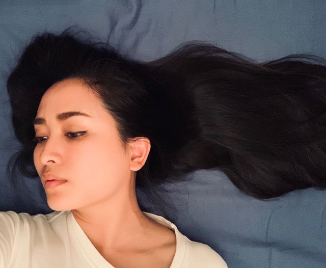gray tone back drop with black long hair with peaceful emontion