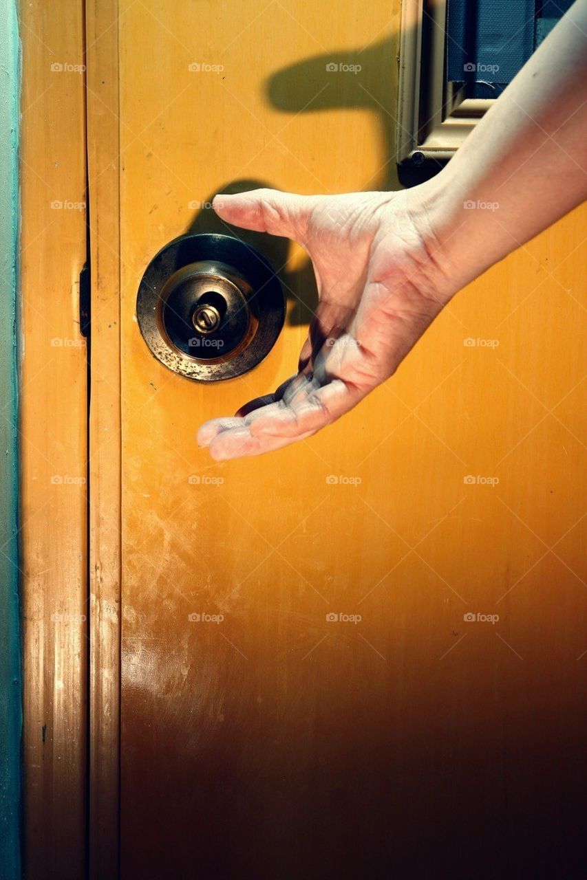 Hand about to open a door