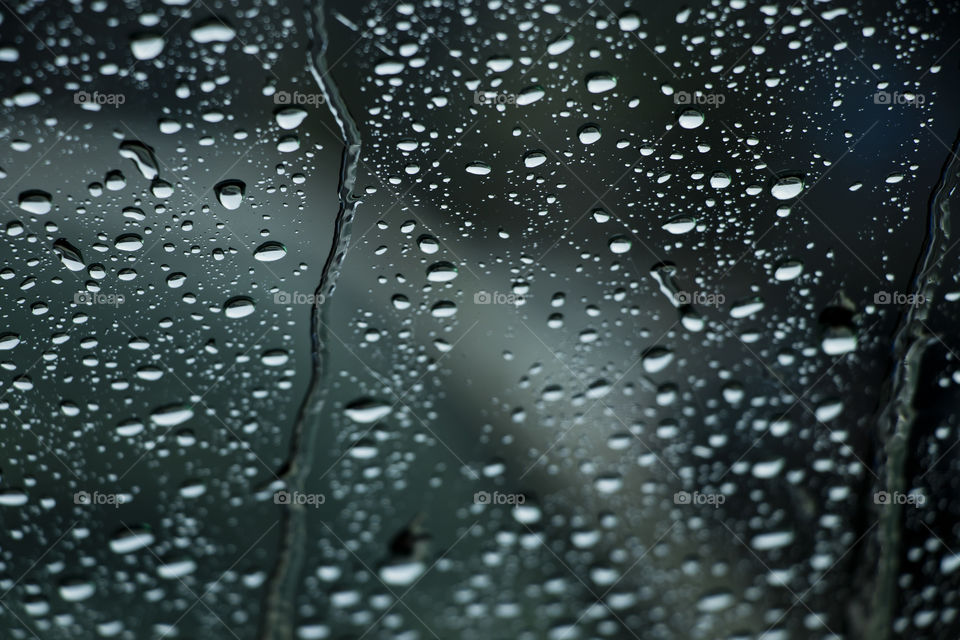 Rain falls outside the window.