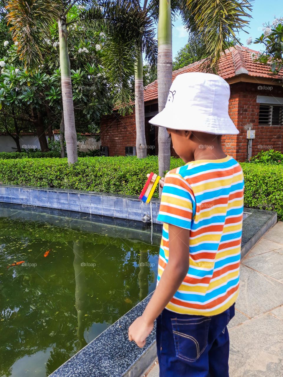 Boy with colorful tshirt and toy in hand