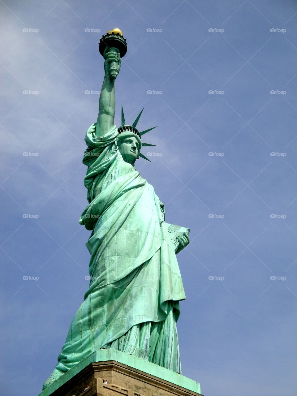 Lady Liberty under blue skies