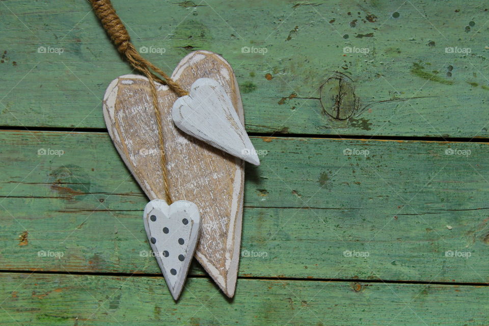 close-up of a wooden heart decorations on a wooden table