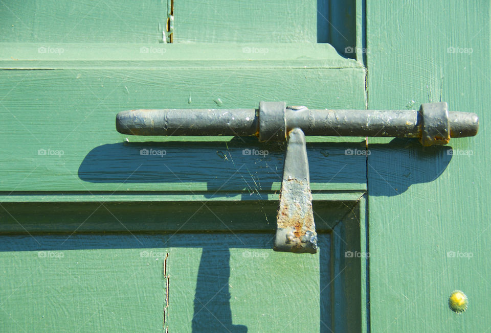 Green Color story; pop of color historic building green door with iron latch