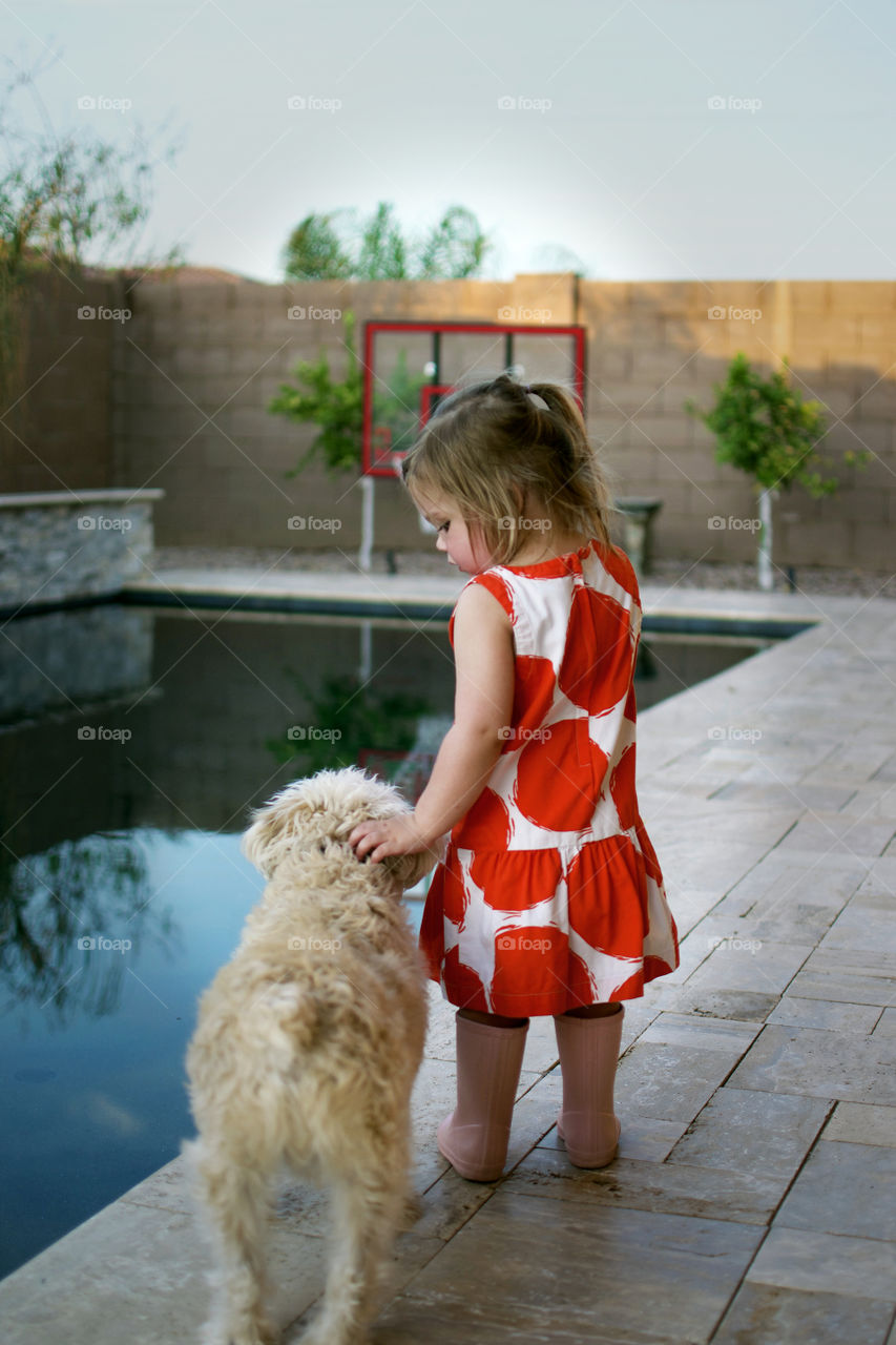 Girl standing with dog 