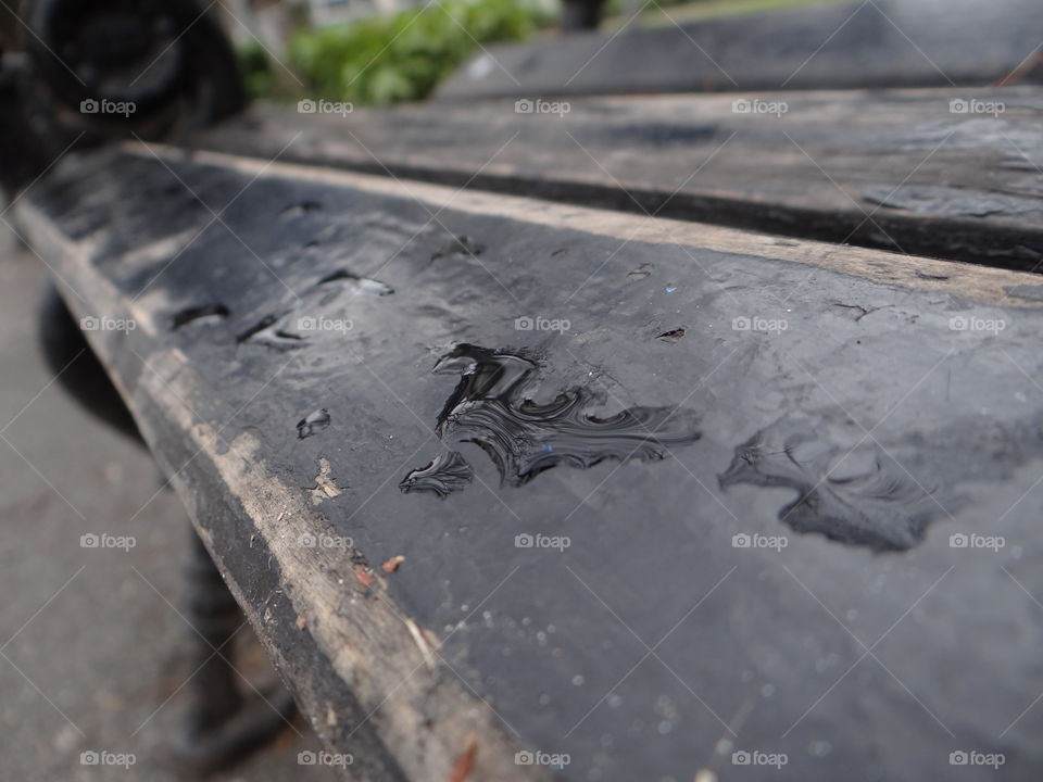 Drop of rain on the city bench