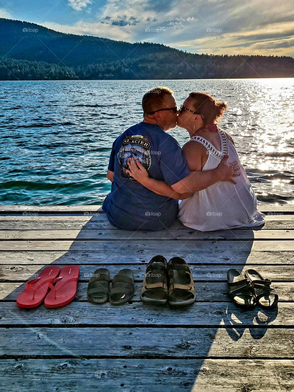 Enjoying a wonderful vacation and a beautiful sunset view of a gorgeous lake led to a sweet kiss