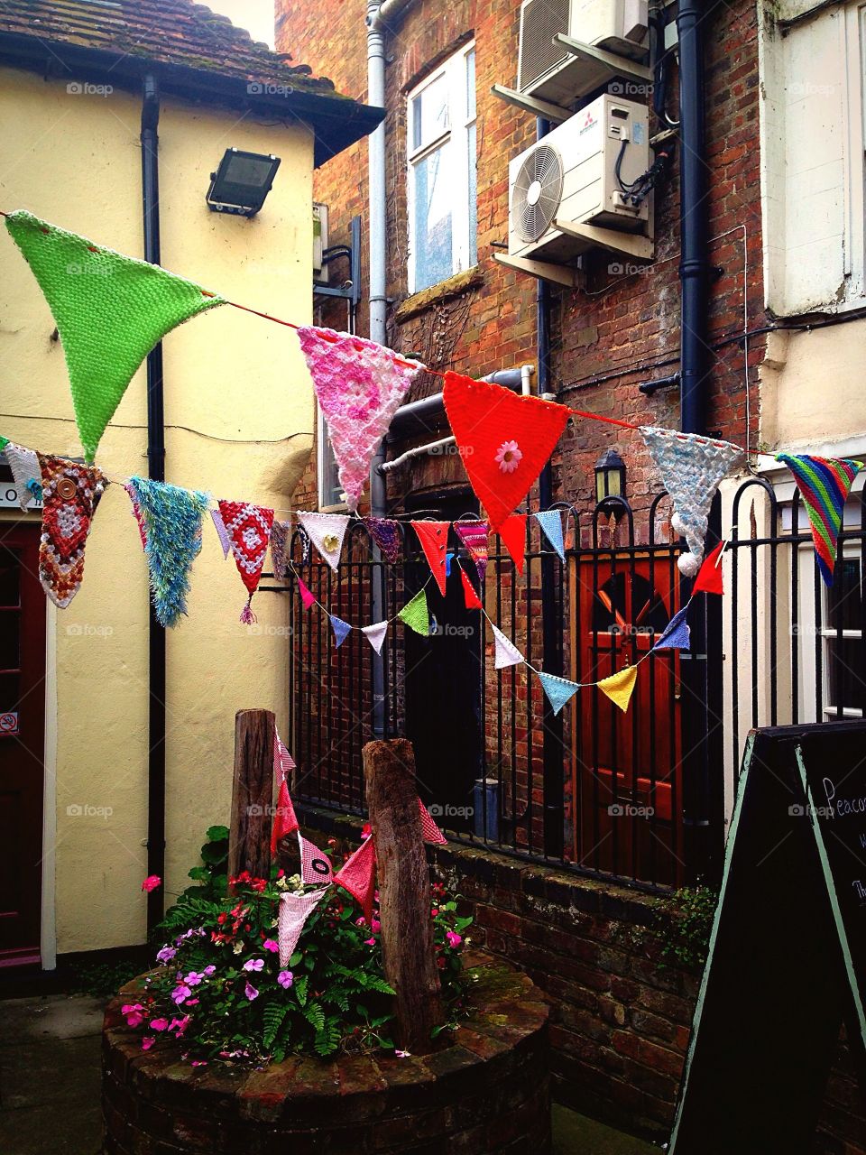 Urban town garden in Bedfordshire England with hand knitted bunting 
