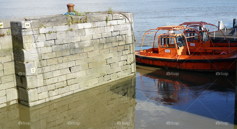 Wall and boats on the riverside