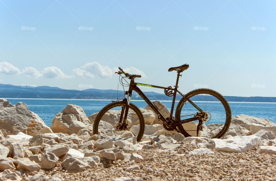 Bicycle parked between rocks