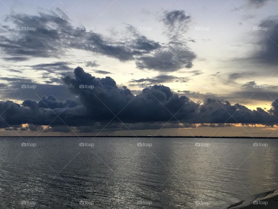 Clouds - Dark colored , puffy storm clouds float over the Choctawhatchee bay just begot the storm