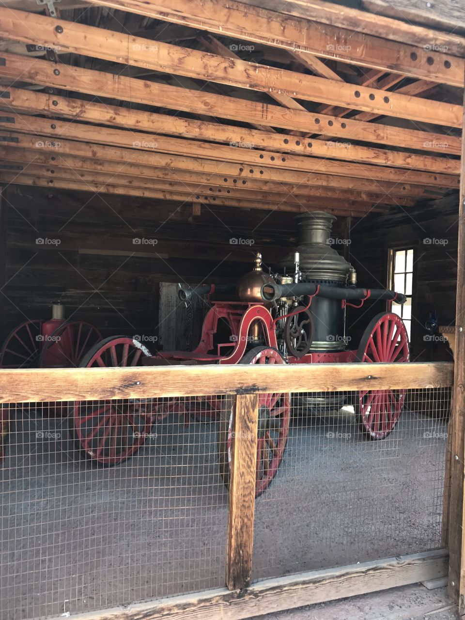 Old antique fire truck behind a fence