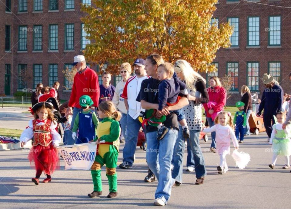 People enjoying Fall . Fall Halloween parade in a small town in Southern Illinois . Local area traditional parade , fall festival , games ..