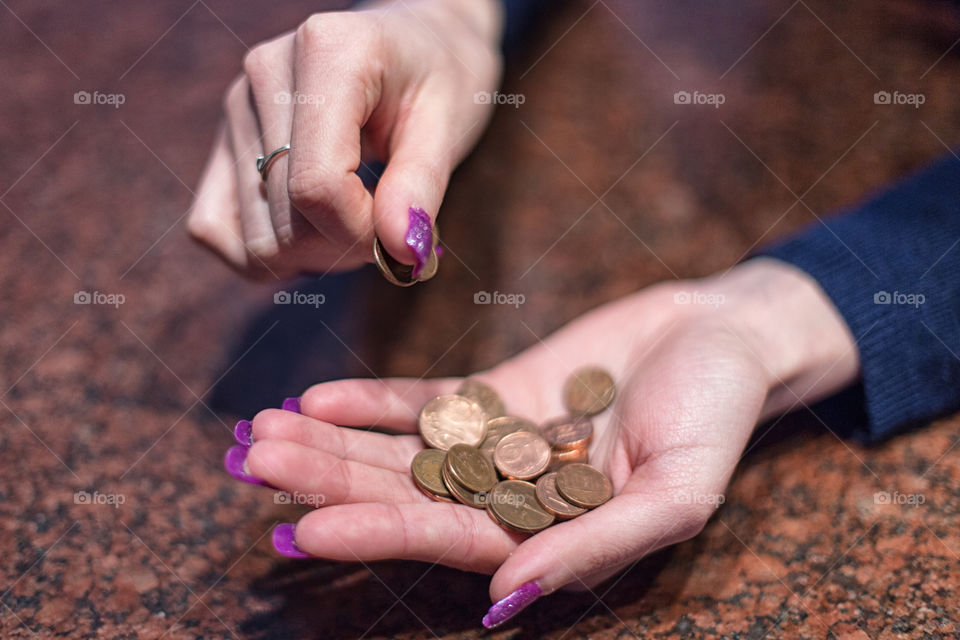 women dropping coins into hand