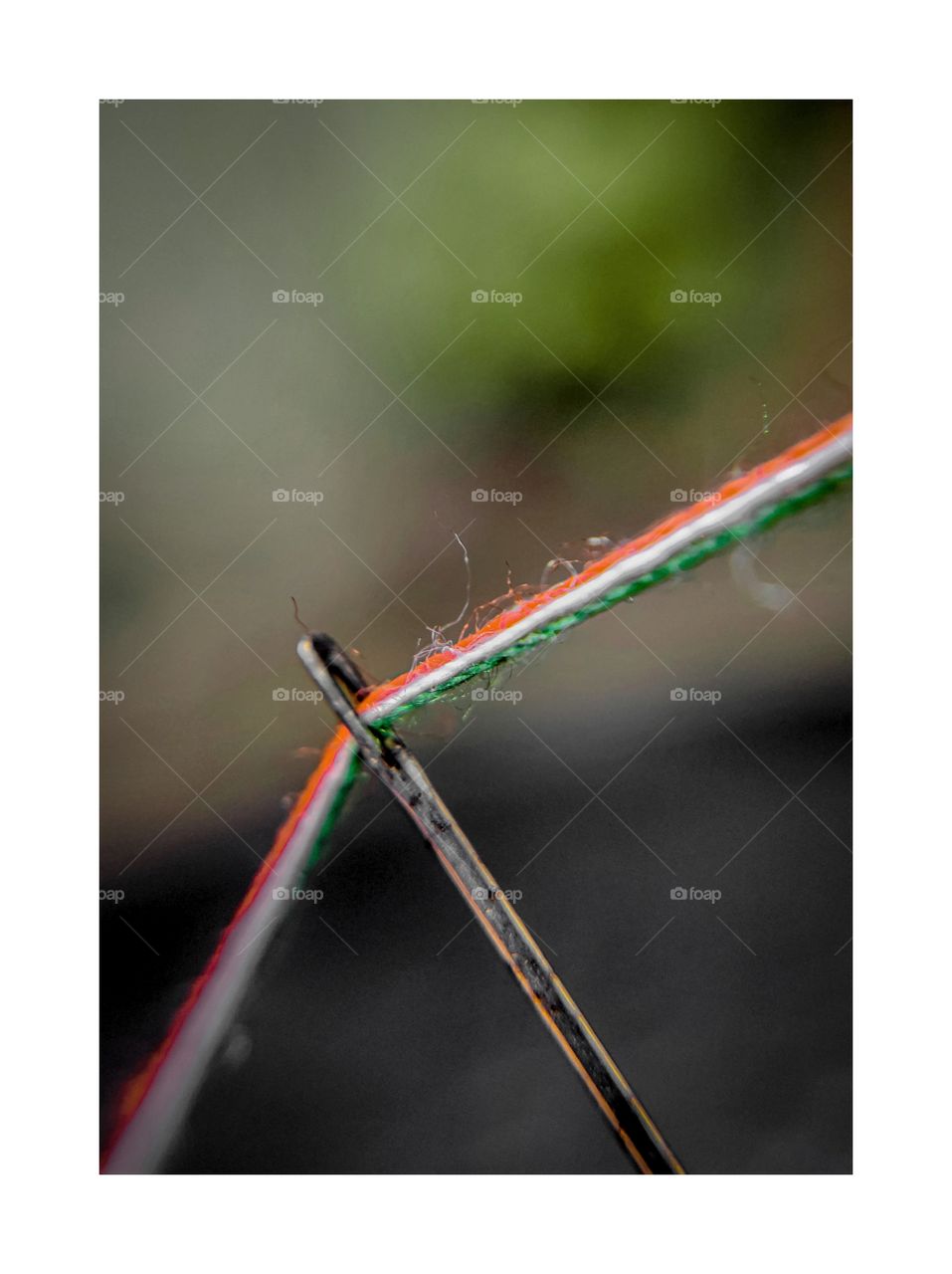 needle and thread making tiranga together.