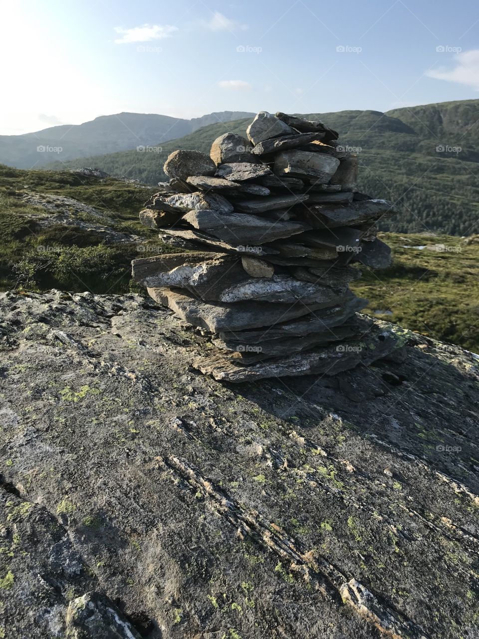 A beautiful pictures from one of the many mountains in Norway. This is a stack of stones built on top of the mountain. It’s really common finding these around in the mountains in Norway.