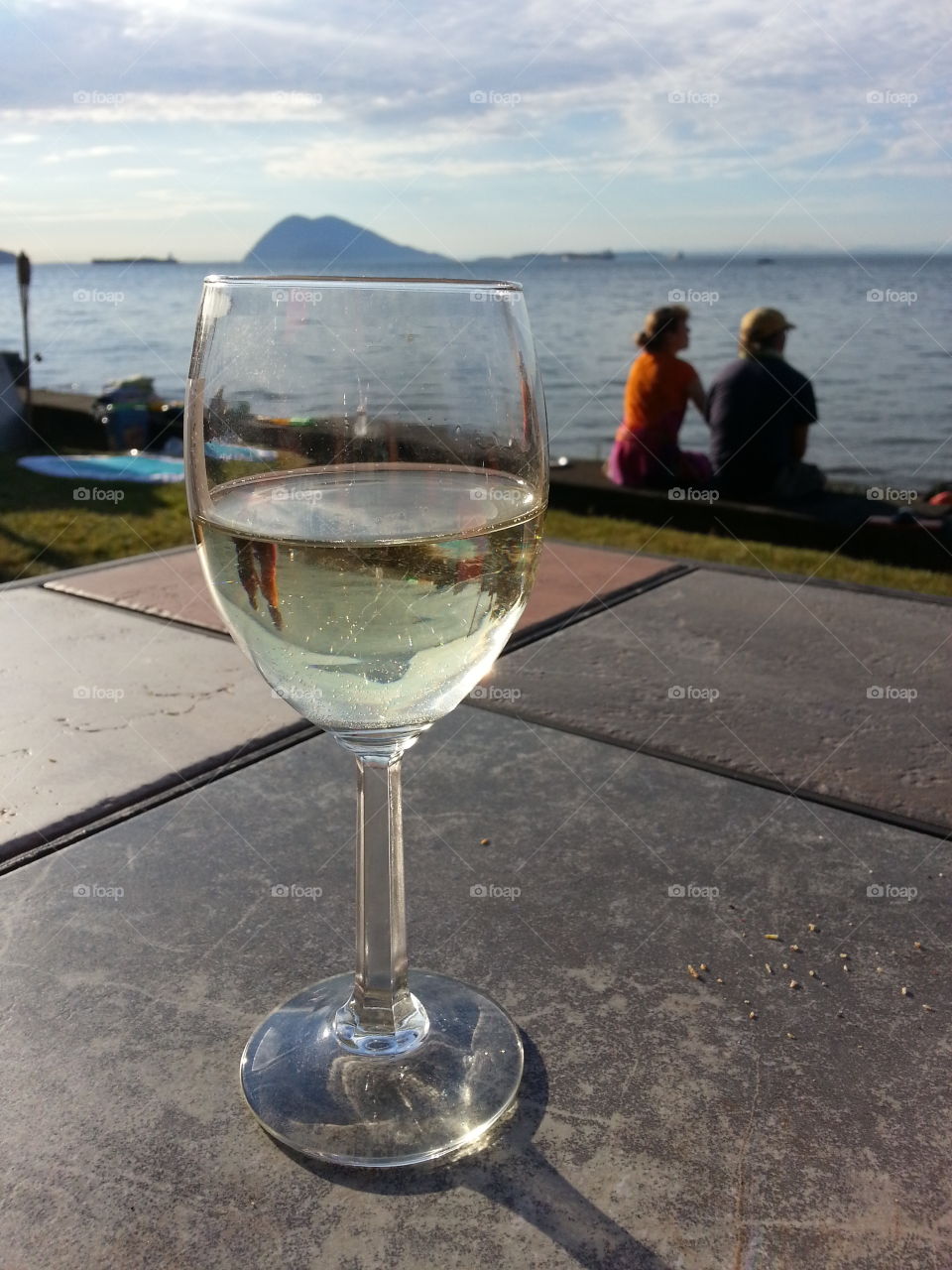 white wine at the beach. enjoying a glass of white wine at the island beach cabin
