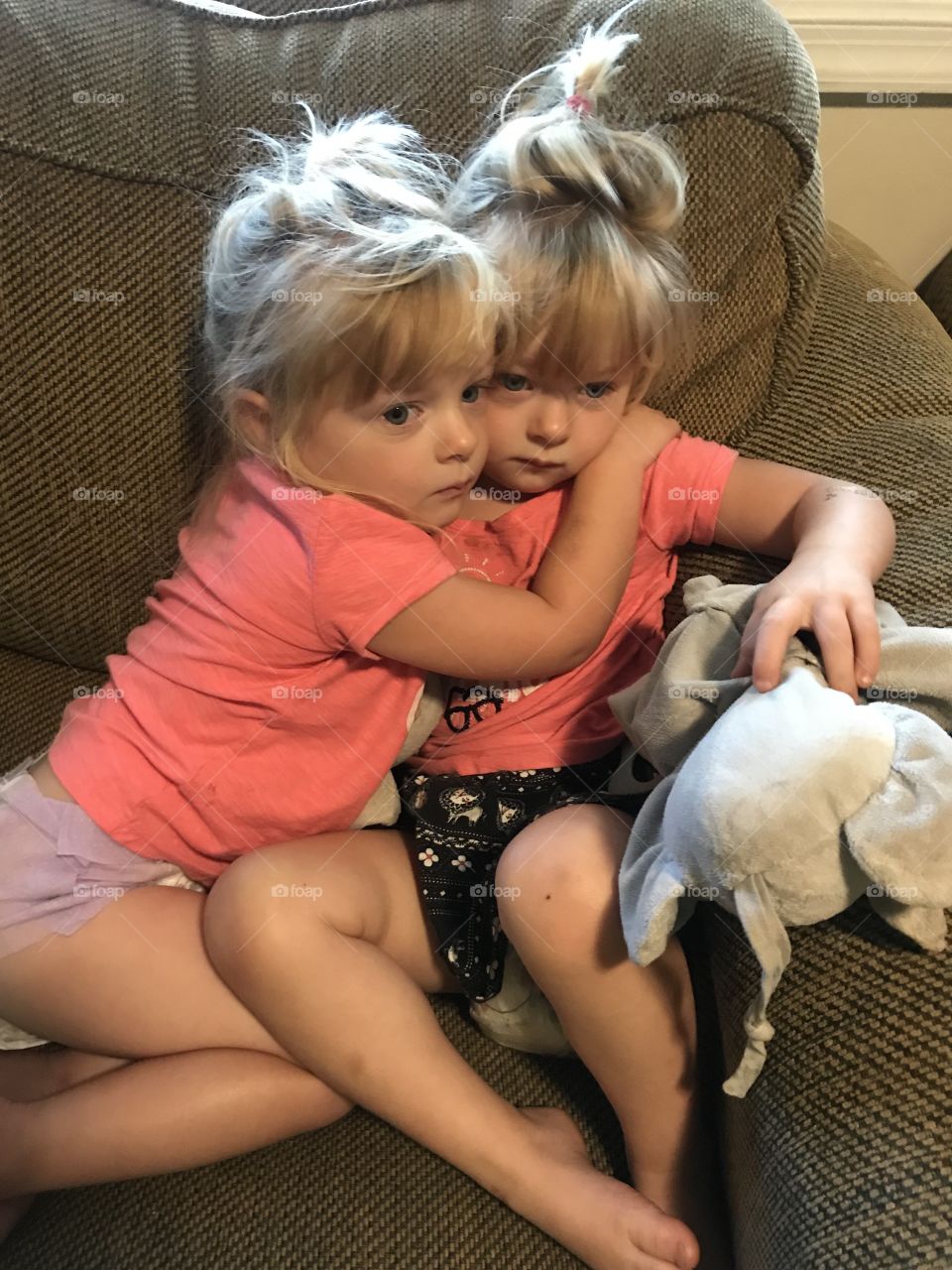 Twin sister hugs. 