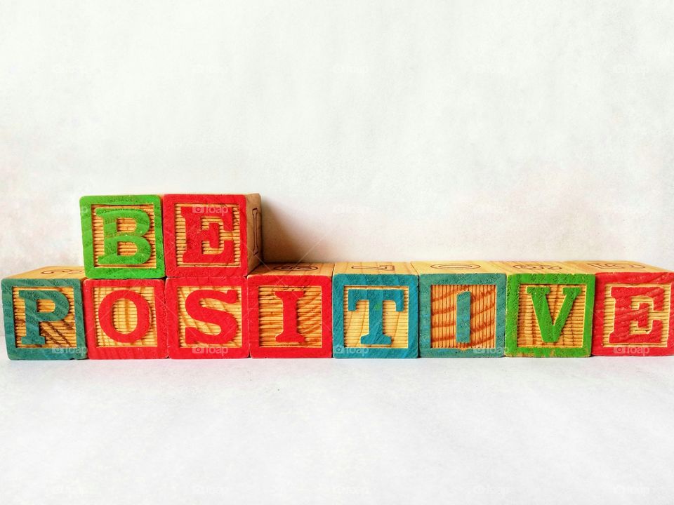 Written :"be positive" with cubes