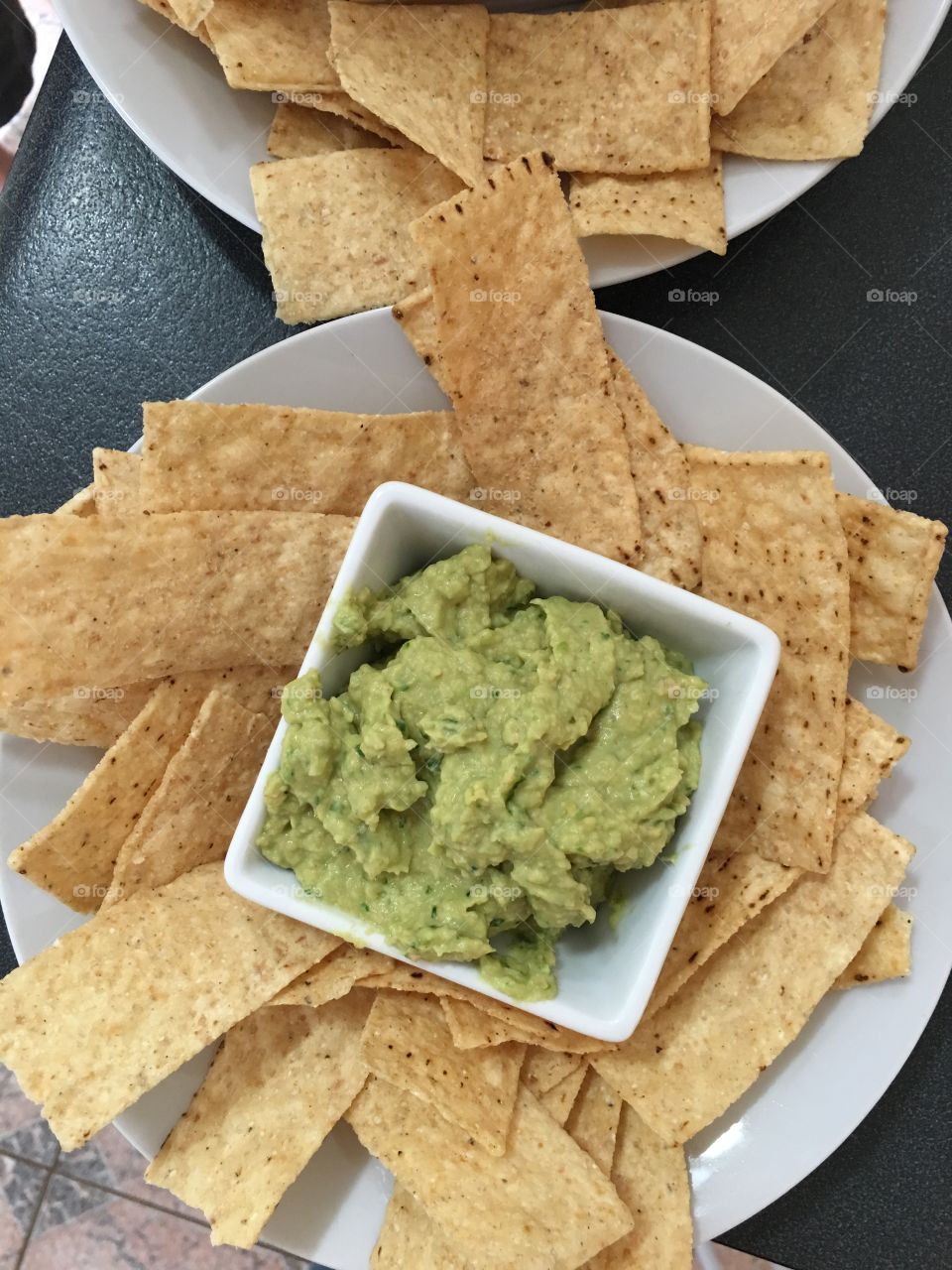 Close up spinach hummus dip with corn chips, homemade 