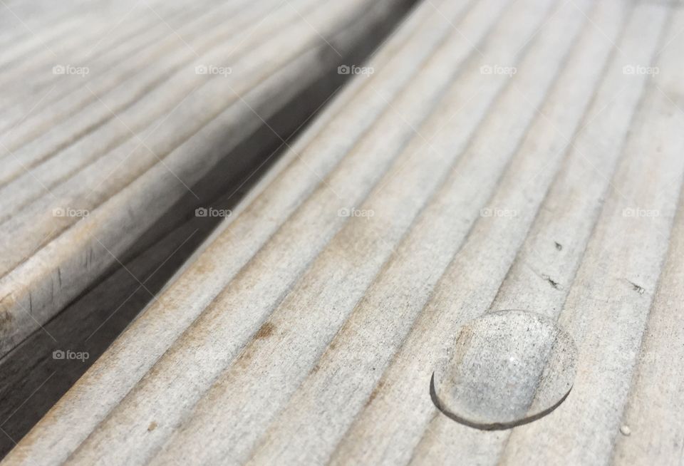Perfect Water drop on light wooden bench