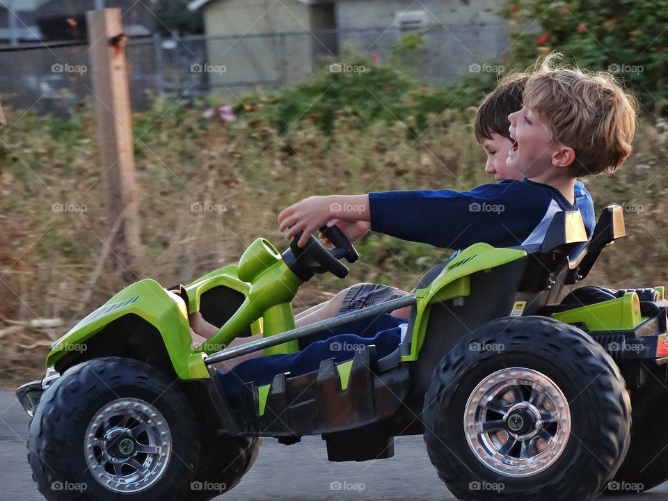 Pure Joy. Young Boys Driving A Miniature Off-Road Vehicle
