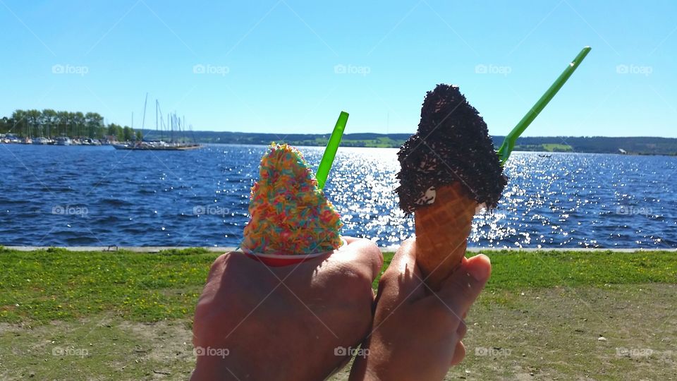 Warm day. Hands holding ice cream.