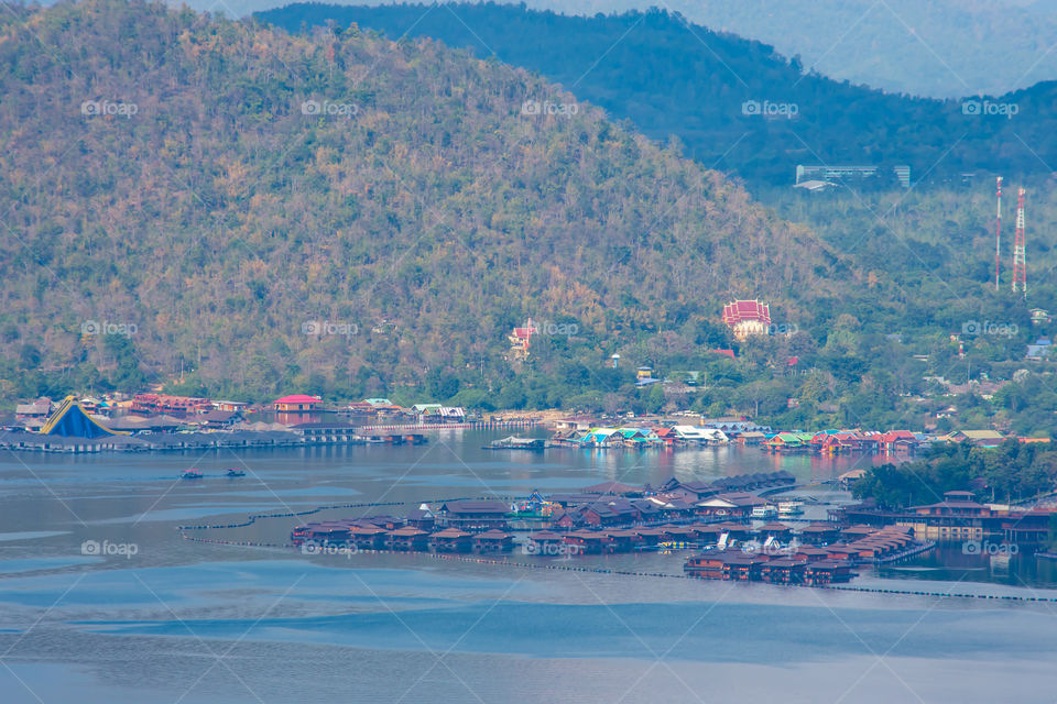 The beauty inside the dam and the houseboat on the bright sky at Sri Nakarin dam , Kanchana buri in Thailand.