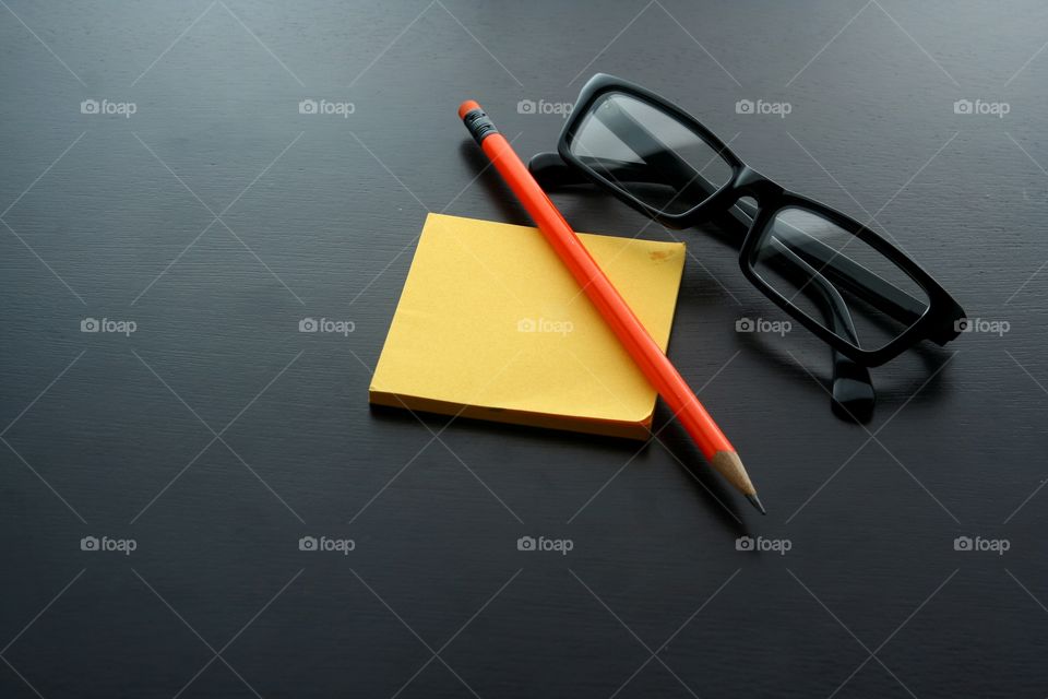 pencil, notepad and eyeglasses. photo of pencil, notepad and eyeglasses