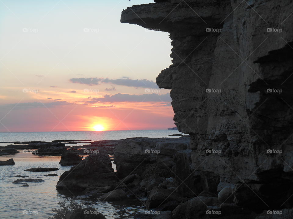 stone face on a sunset sea beautiful summer seascape art nature