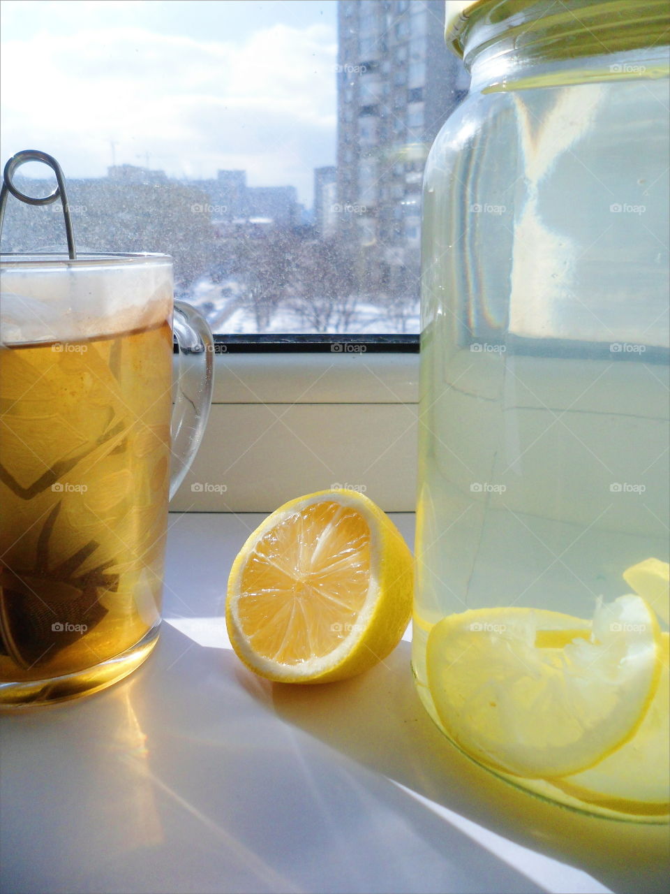 home lemonade with lemon and a cup of tea