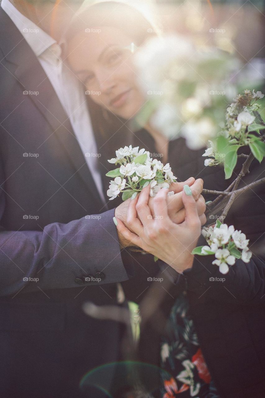 bride and groom hold spring flowers in their hands